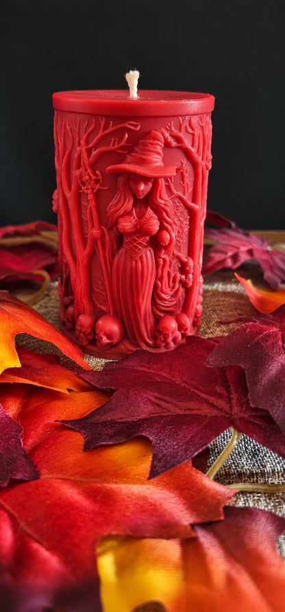 Red Grovekeeper sculptural candle with a forest witch and branching woodland details.