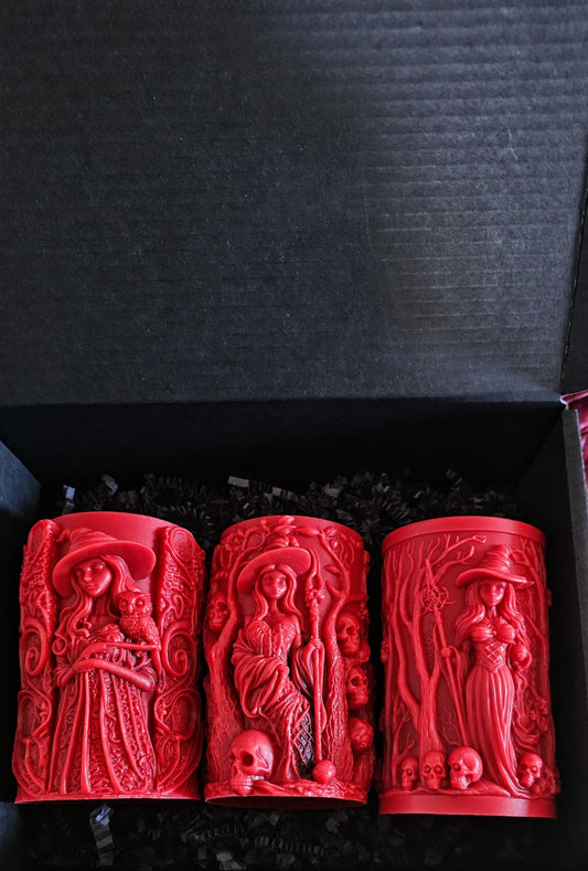Wisdomkeeper, Bonekeeper and Grovekeeper red candles together in a black box with black paper shred.